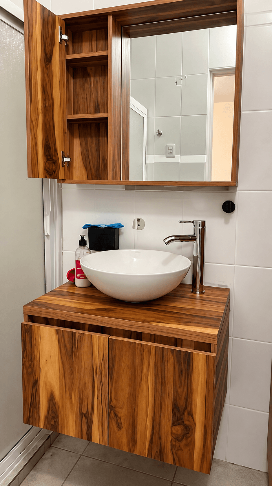 Custom wood mirror cabinet mounted above a bathroom vanity