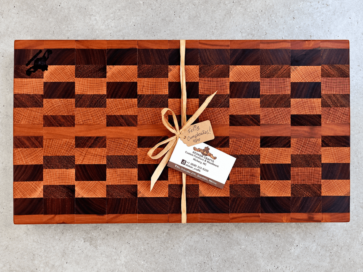End-grain wood cutting board with a handle cutout